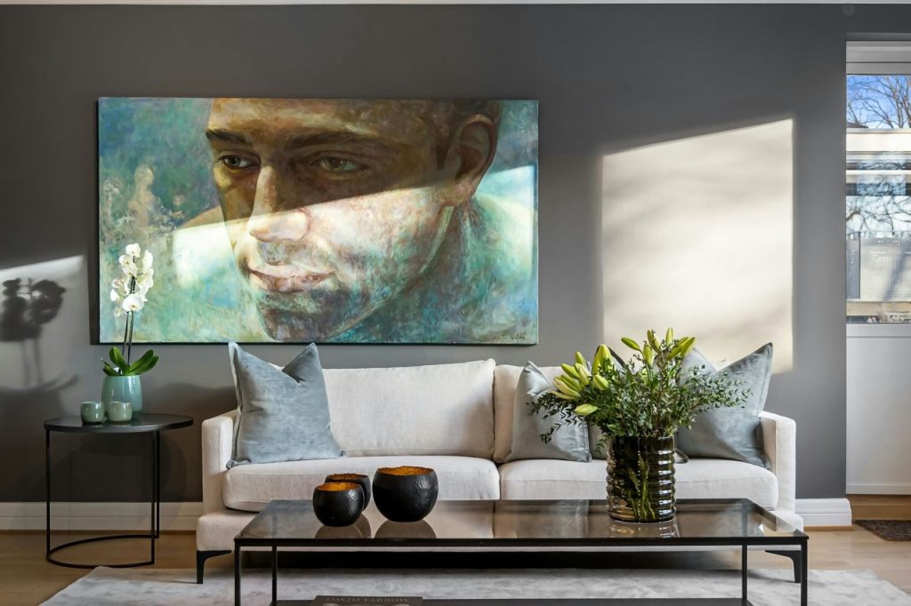 Curated living room styling with contemporary artwork, elegant furnishings, and layered textures — personalized design guidance by Lucie Pitt.