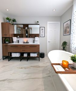 Modern bathroom with wood vanity, freestanding tub, and marble floors in a luxury Montreal renovation