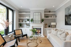 Elegant living room with built-ins, a cozy fireplace, and modern decor in a luxury Montreal renovation