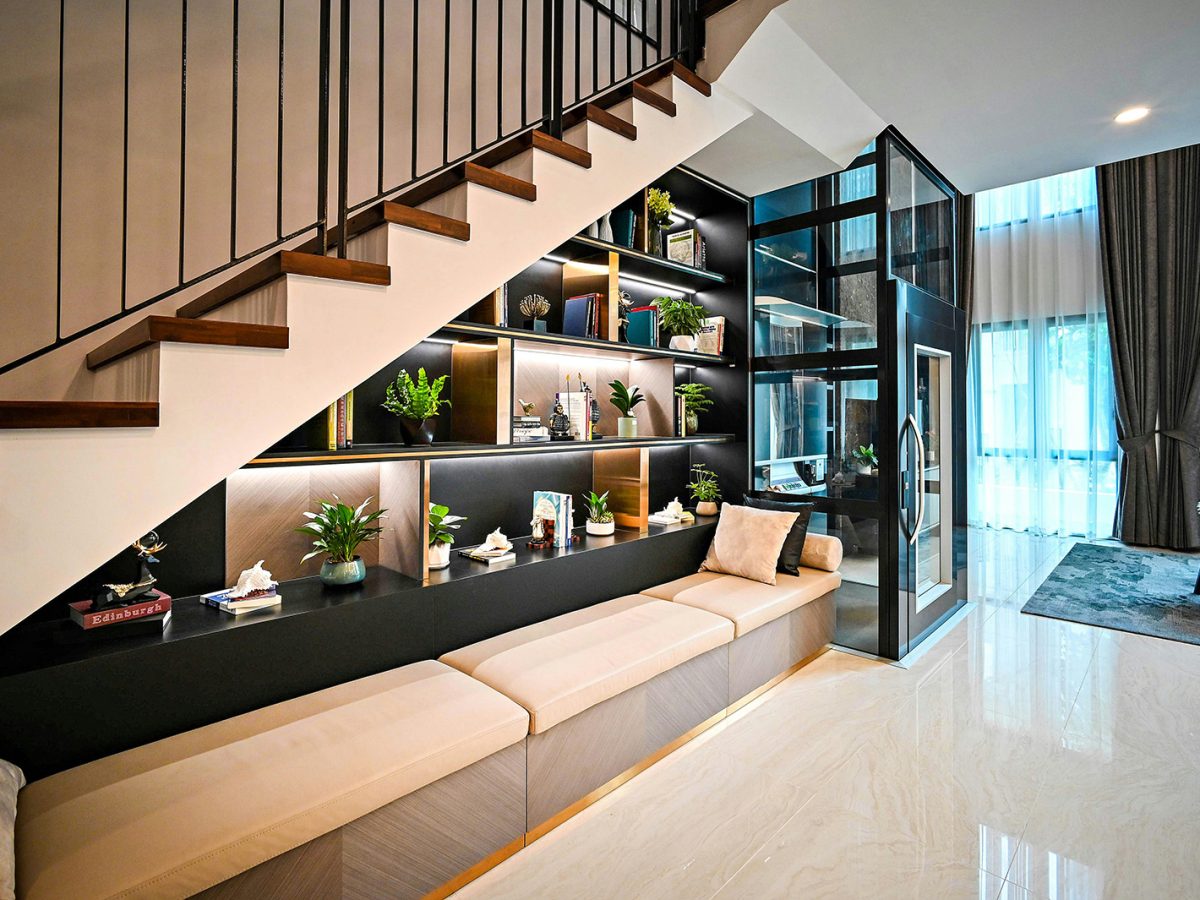 Bespoke built-in shelving and custom cabinetry beneath a modern staircase — refined craftsmanship and architectural millwork by Lucie Pitt.