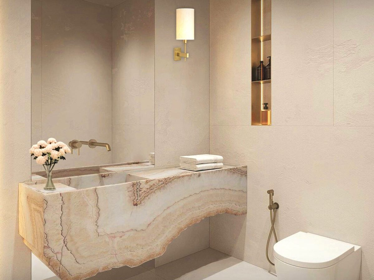 Luxury bathroom with sculpted onyx vanity, warm lighting, and refined architectural finishes — meticulous project coordination and management by Lucie Pitt.