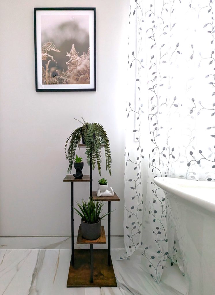 Serene bathroom vignette with freestanding tub, soft sheer curtains, and curated greenery — from Lucie Pitt’s Laval Harmony spa-inspired design.