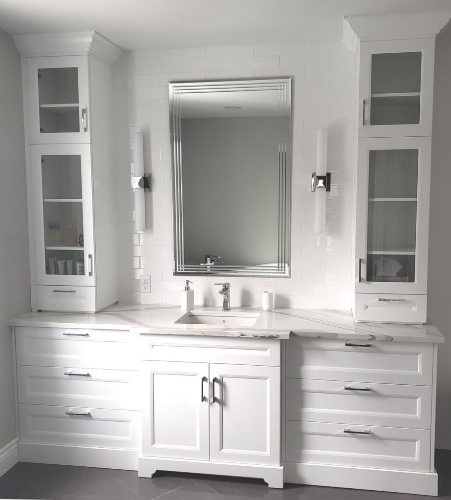Luxury spa-inspired bathroom with white vanity, integrated lighting, chrome fixtures, and marble-look quartz surfaces — part of Lucie Pitt’s West Island Spa Retreat project.
