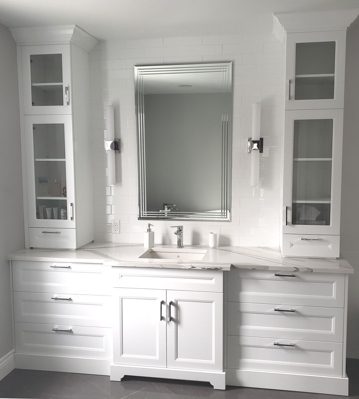 Luxury white bathroom vanity with custom cabinetry, marble countertop, and elegant built-in storage design by Lucie Pitt.
